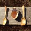 A hand carved arbutus coffee cup and acouple of spoons